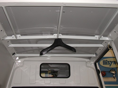 Rails installed for transporting clothes on a Syncro Canada van